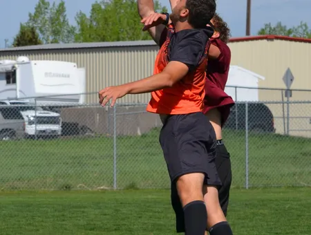 Two players going up for the disc at a field tournament