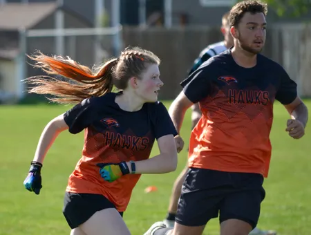 BHAA Hawks teammates sprinting downfield in formation